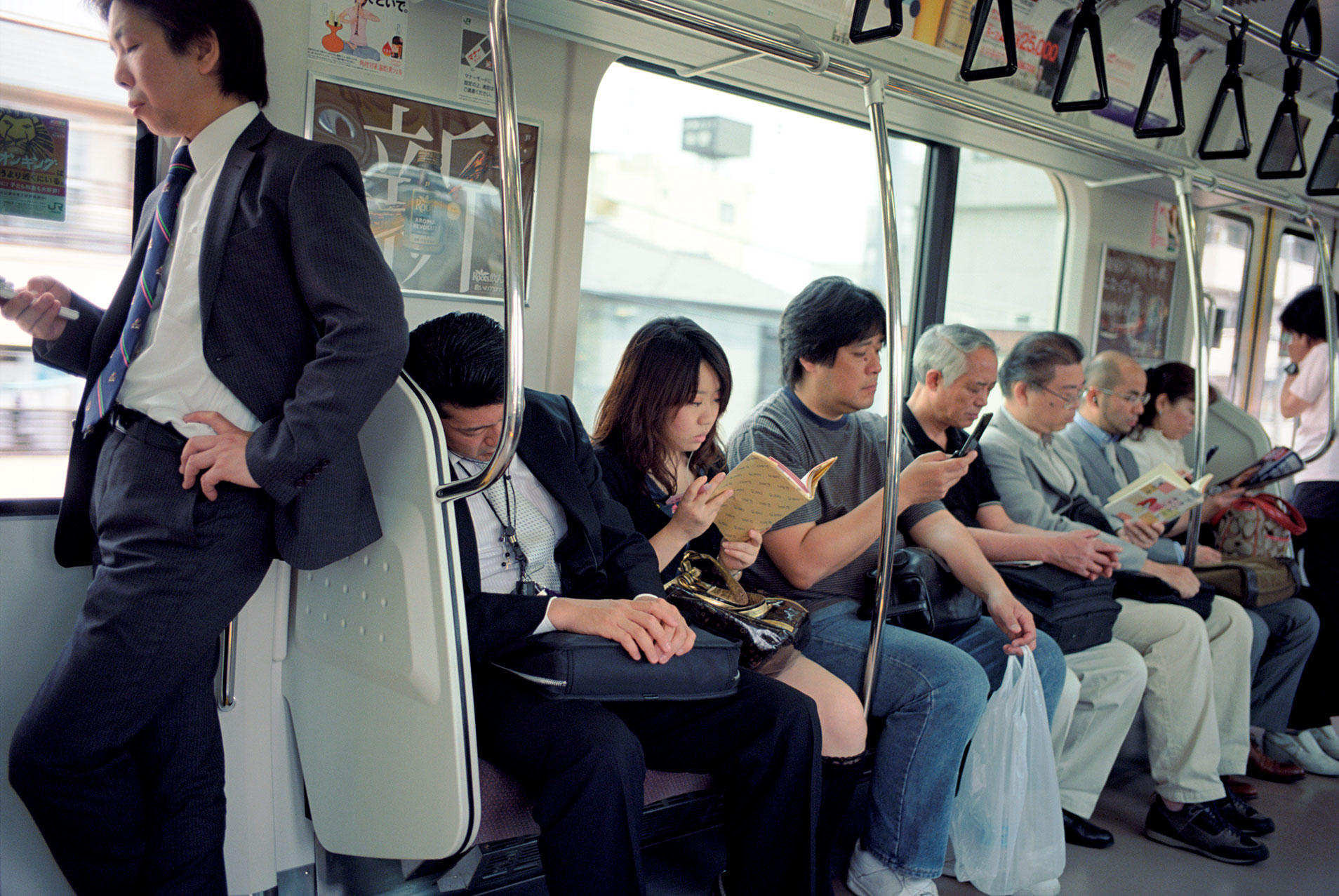 Commuters relaxing on the Chuo Line train to Tachikawa from Tokyo in 2009.