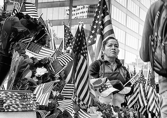 A Latina street vendor was selling American flags at a new citizen ceremony in Oakland, California, in 2015.