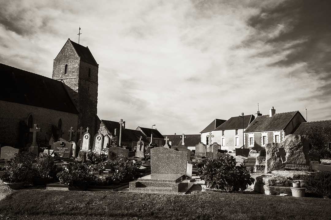 A church, homes, and cemetery in Vouilly, France, in 2016.