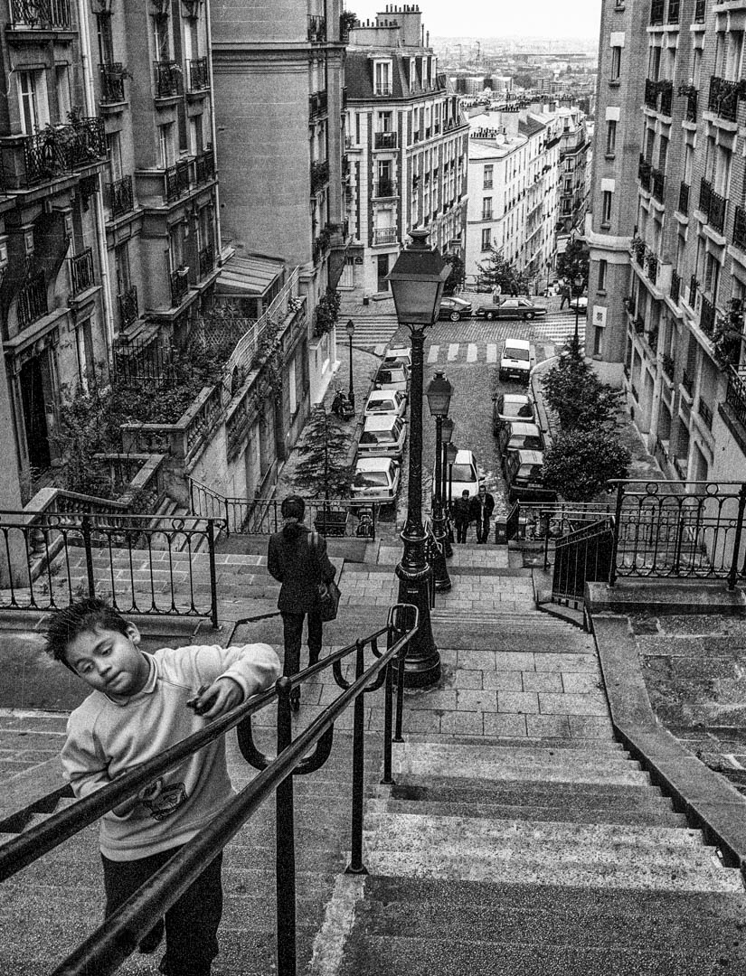 A young boy runs up Montmartre steps, Paris, 2002.