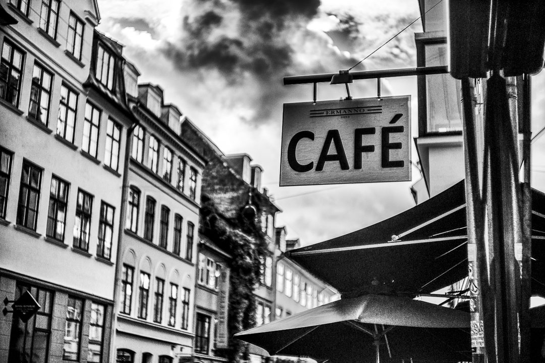 A cafe sign over umbrellas in Nyhavn, Copenhagen, in 2019.