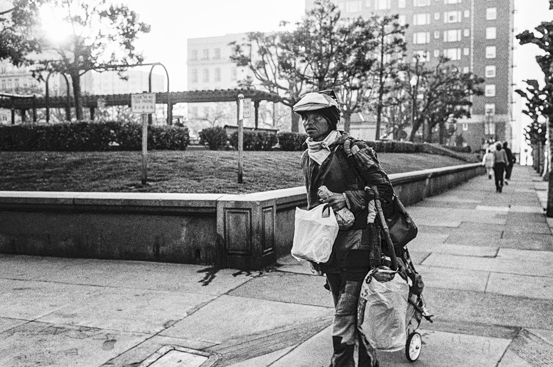 A homeless woman with cart walks along Taylor Street, Nob Hill, in San Francisco, in 1991.